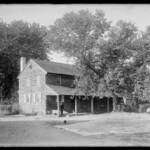 Old home of Job and Elizabeth Collins near Medford. Rear view with one standing figure.